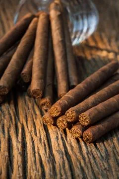 Background, pile of small cigar on old wooden table Stock Photos