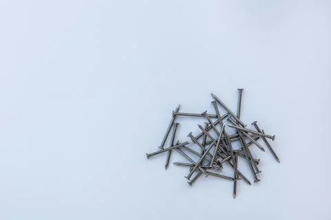 Background of piled wood nails on a solid backdrop Stock Photos