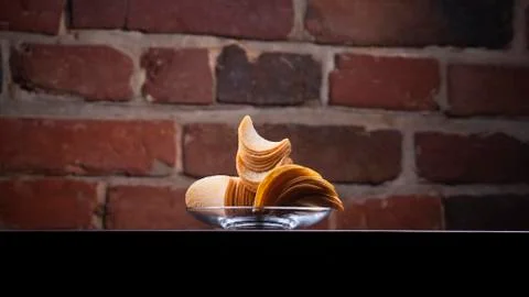 Background with plate full of potato chips Stock Photos
