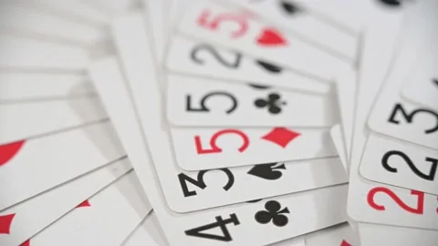 Background playing cards are neatly laid out on the table. Stock Footage 154806789