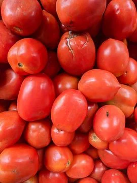Background portrait of tomato vegetable fruit at a fruit vendor Stock Photos
