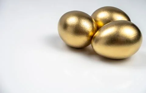 Background, postcard, with three Golden eggs on white background for text inp Stock Photos