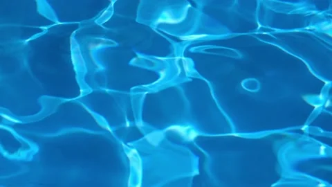 Background of pure dark blue water in swimming pool with light sun reflections Stock Footage 200878316