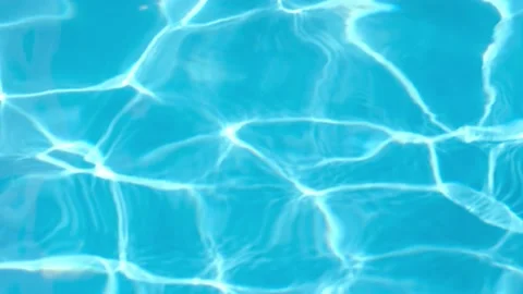 Background of pure light blue water surface in swimming pool with sun reflection Video stock 200932344