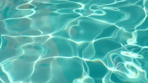 Background of pure light turquoise water in swimming pool with sun reflection Video stock 201281632