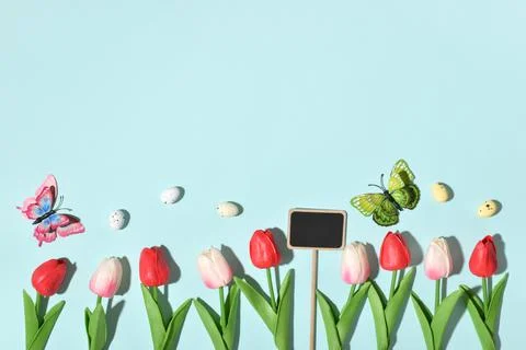 Background with rabbit ears, Easter eggs and tulip flowers. Stock Photos