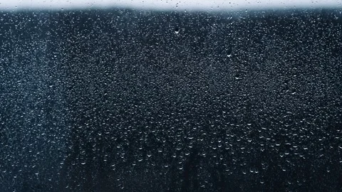Background of Raindrops Slowly Flow Down the Glass of the Window Timelapse Stock Footage 262268125
