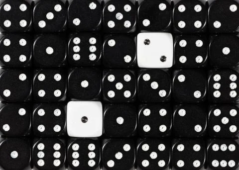 Background of random ordered black dices with two white cubes Stock Photos
