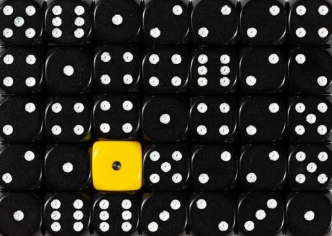Background of random ordered black dices with one yellow cube Stock Photos