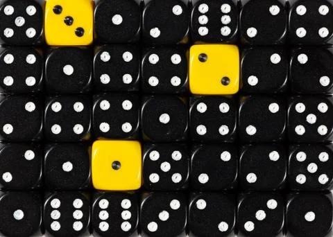 Background of random ordered black dices with three yellow cubes Stock Photos