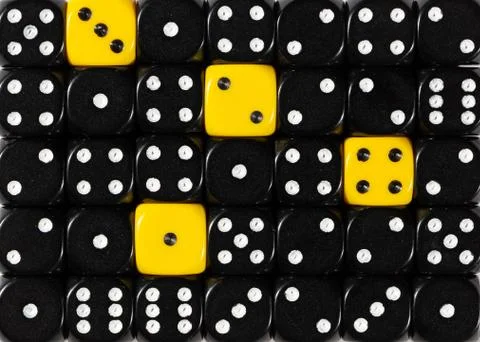 Background of random ordered black dices with four yellow cubes Stock Photos