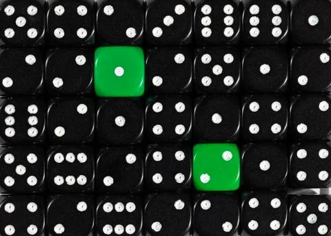 Background of random ordered black dices with two green cubes Stock Photos