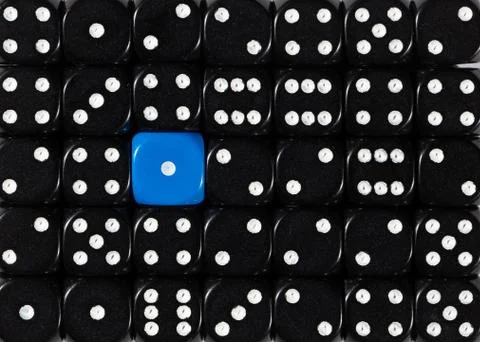 Background of random ordered black dices with one blue cube Stock Photos