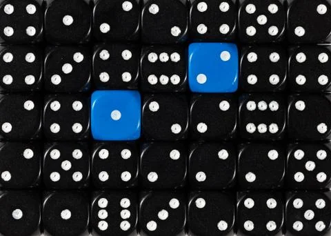 Background of random ordered black dices with two blue cubes Stock Photos