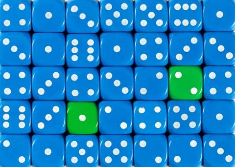 Background of random ordered blue dices with two green cubes Stock Photos