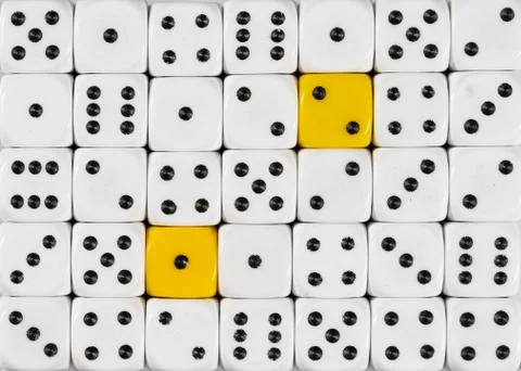Background of random ordered white dices with two yellow cubes Stock Photos