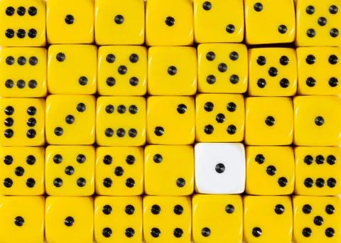 Background of random ordered yellow dices with one white cube Stock Photos