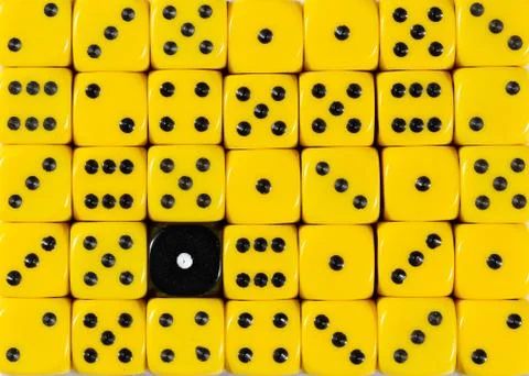 Background of random ordered yellow dices with one black cube Stock Photos