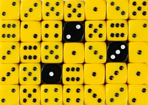 Background of random ordered yellow dices with three black cubes Stock Photos