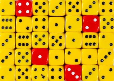 Background of random ordered yellow dices with four red cubes Stock Photos