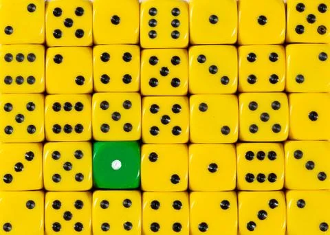 Background of random ordered yellow dices with one green cube Stock Photos