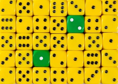 Background of random ordered yellow dices with two green cubes Stock Photos