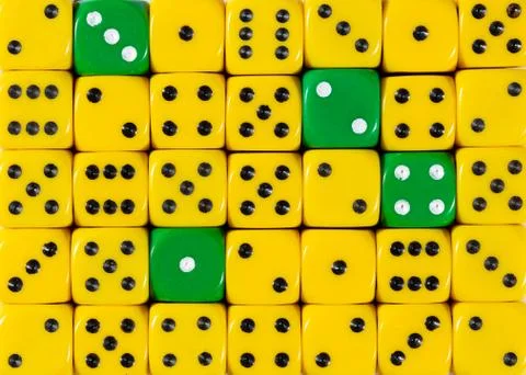 Background of random ordered yellow dices with four green cubes Stock Photos