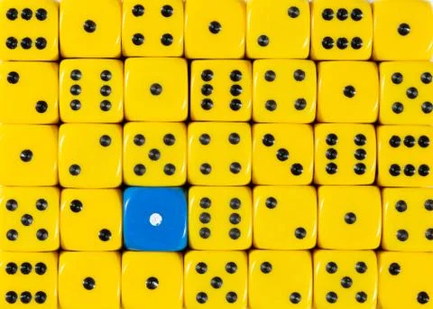 Background of random ordered yellow dices with one blue cube Stock Photos