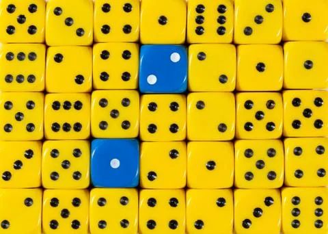 Background of random ordered yellow dices with two blue cubes Stock Photos