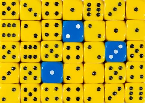 Background of random ordered yellow dices with three blue cubes Stock Photos
