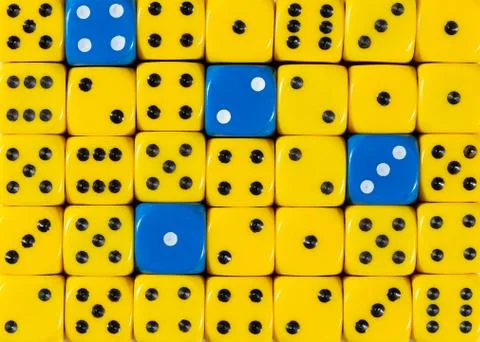 Background of random ordered yellow dices with four blue cubes Stock Photos