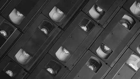 Background of real VHS cassettes sliding to the right, black and white, top view Stock Footage 155883542