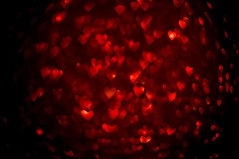 Background with red bokeh in the shape of a heart. Stock Photos