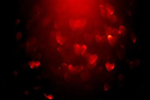 Background with red bokeh in the shape of a heart. Stock Photos