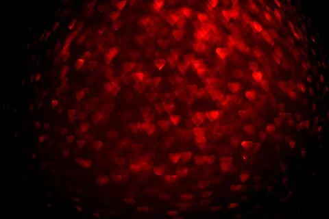 Background with red bokeh in the shape of a heart. Stock Photos