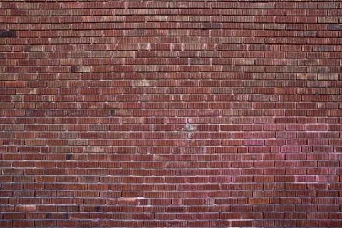 Background of red brick wall pattern texture. Great for graffiti inscriptions. Stock Photos