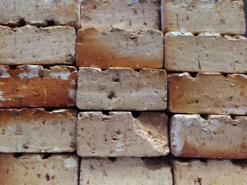 Background of red bricks stacked without cement and in a rustic way. Stock Photos