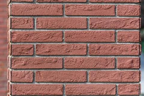 Background of red cement bricks in direct sun light, geometrical pattern Stockfoto's