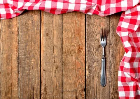 Background with red checkered tablecloth top and right frame and fork on vintage Stock Photos