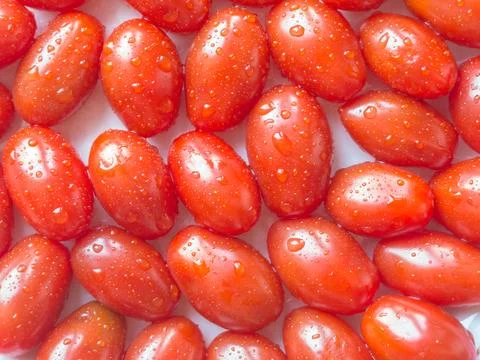 Background of red cherry tomatoes. Stock Photos