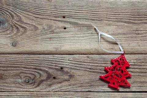 Background with red Christmas decorations tree on old wooden boards. Stock Photos