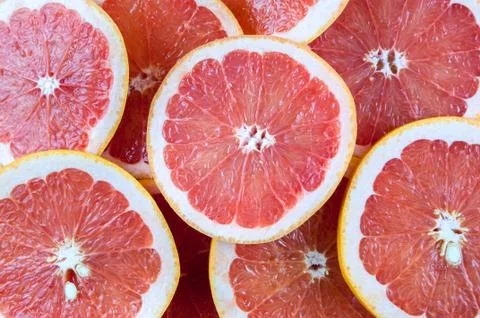 Background of red grapefruit slices Stock Photos