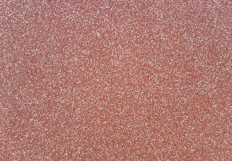 Background of red plaster with white flecks. Red plaster texture Stock Photos