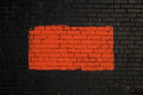 Background Red rectangle painted on black brick wall Foto stock