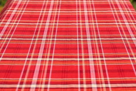 Background of red textile material with coloured stripes Stock Photos