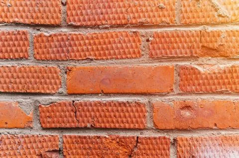 Background of red textured relief brick. aged old stone wall or street textur Stock Photos