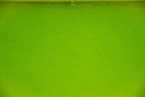 Background with relief plaster covered with green paint. Green empty space. Stock Photos