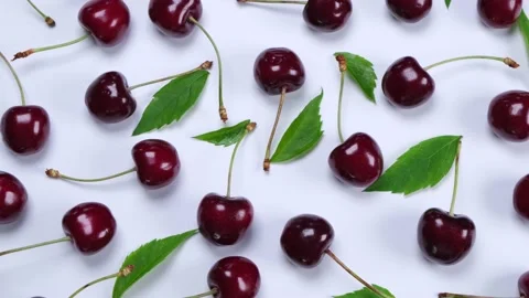 Background of ripe cherries with water drops on white background with green Stock Footage 197573426