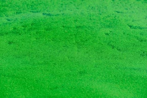 Background of the ripples on the water with green algae Foto stock