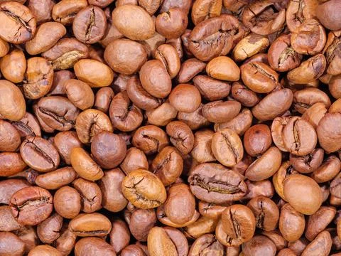 Background of roasted brown coffee beans closeup Stock Photos